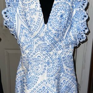 blue and white embroidered romper with ruffle sleeves and eyelet lace details